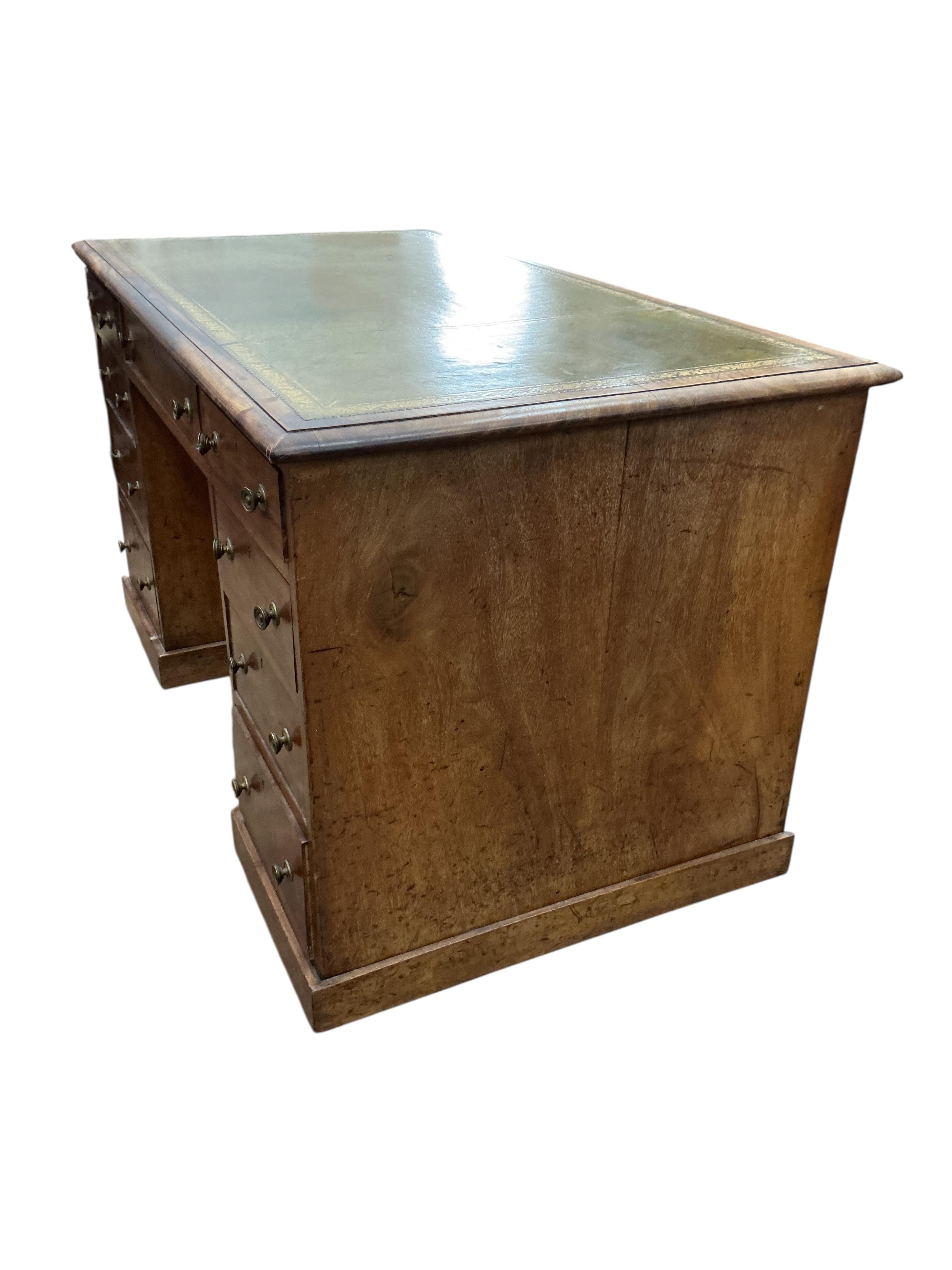 A Victorian faded mahogany kneehole desk with leather inset top, width 127cm, depth 71cm, height 77cm